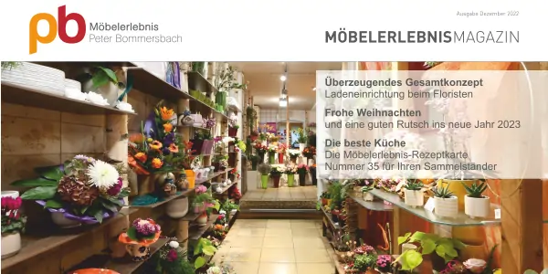 Blick in einen Floristikladen mit Regalen voller bunter Blumen und Pflanzen, Holzmöbel mit Birkenstämme und warmem Licht.